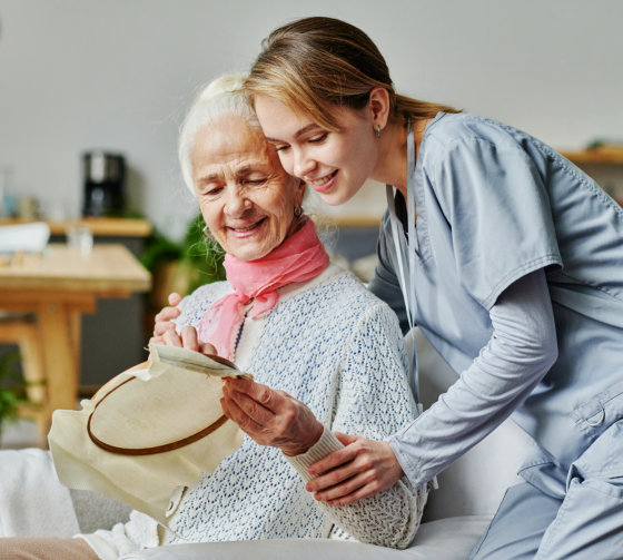 happy senior woman and caretaker