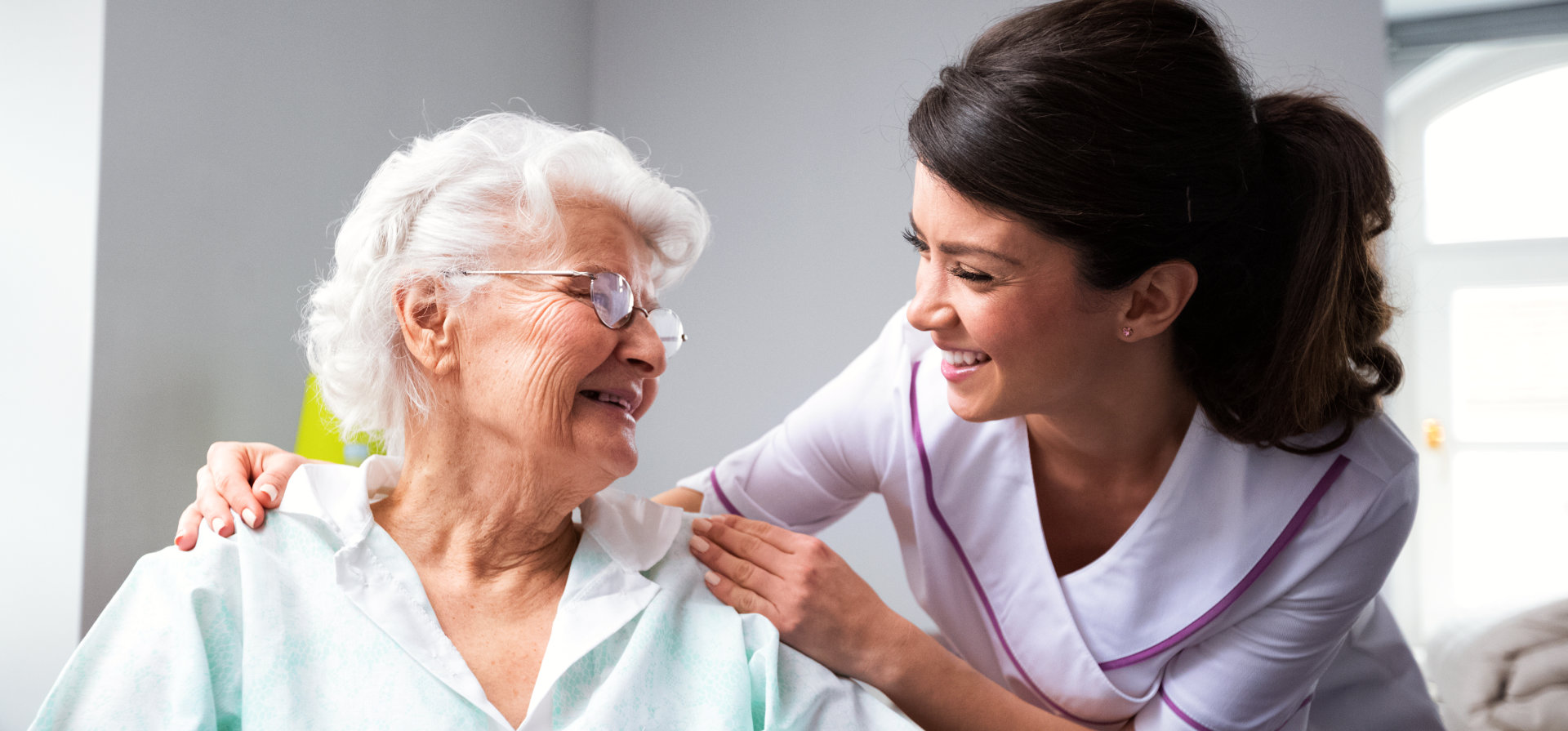 happy senior woman with her caretaker